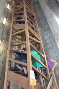 The author and her children climb a tight wooden spiral staircase