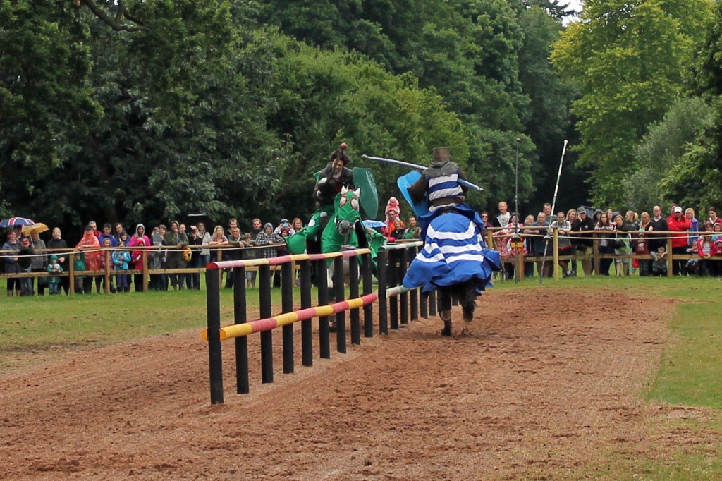 Riders in medieval costume face off in a jousting match