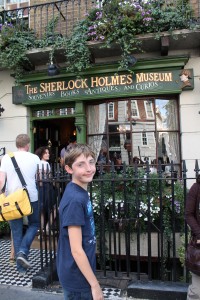 The author's son smiling in front of the Sherlock Holmes Museum