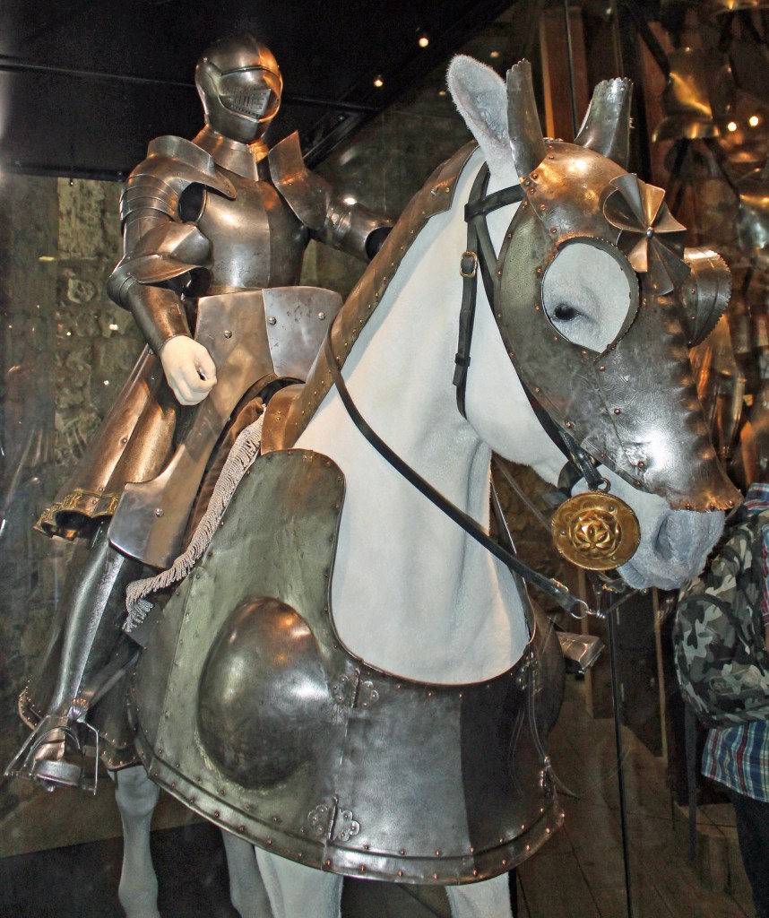 A dummy in armor sitting on an armored horse.