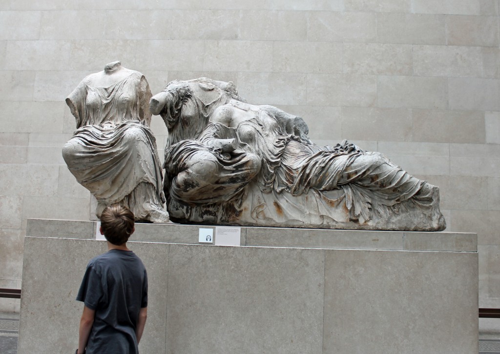 The author's son gazing at headless statues of three Greek goddesses