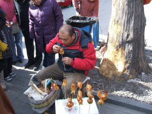 Artist creating blown candy animals at the Dong Yue Temple Fair