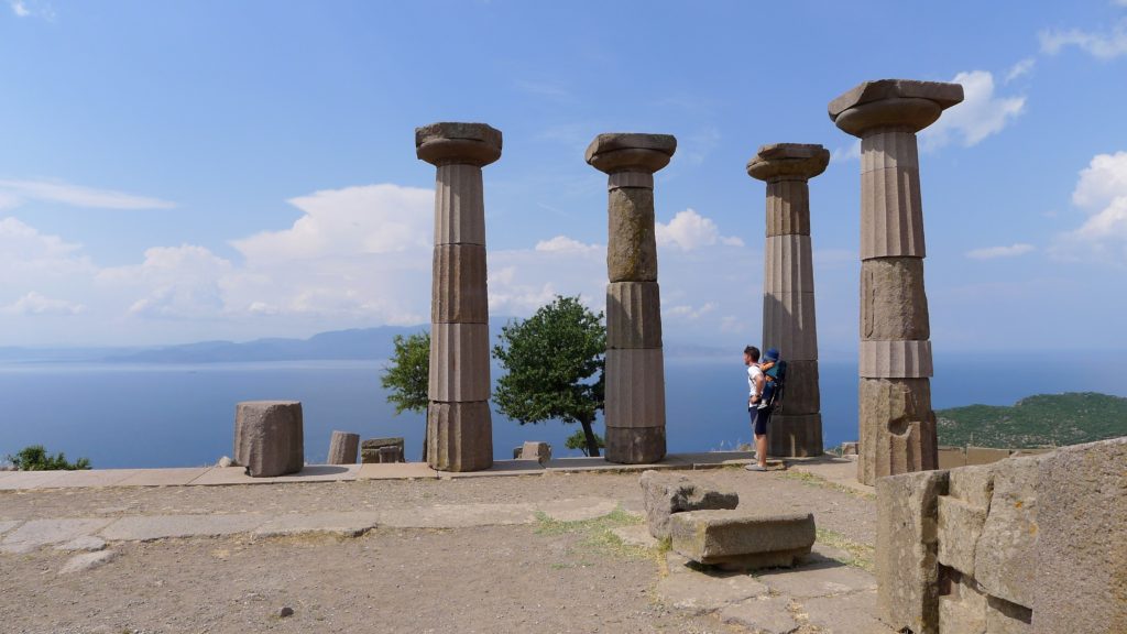 The author in a ruined temple with his son on his back