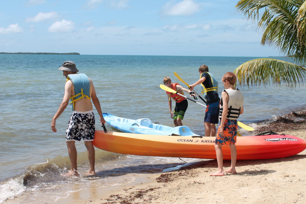The author's family launches kayaks from the beach